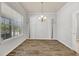 Dining room with hardwood floors, a chandelier, and tree-themed wall decals at 3510 Brook Crossing Dr, Brandon, FL 33511