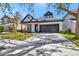 Inviting home showcasing a lush lawn, attractive black trim, and a practical attached two-car garage at 3510 Brook Crossing Dr, Brandon, FL 33511