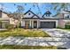 Charming home featuring a manicured lawn, stylish black trim, and an attached two-car garage at 3510 Brook Crossing Dr, Brandon, FL 33511