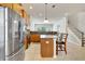 Well-lit kitchen with granite countertops, stainless steel appliances, and a central island with bar seating at 3510 Brook Crossing Dr, Brandon, FL 33511