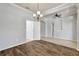 Open living space featuring hardwood floors, a chandelier, and a seamless transition to other areas of the home at 3510 Brook Crossing Dr, Brandon, FL 33511