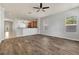 Large living room featuring wood-look floors, ceiling fan, and an open floor plan that overlooks the kitchen at 3510 Brook Crossing Dr, Brandon, FL 33511