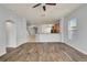 Bright and airy living room with wood-look floors and an open view of the staircase and kitchen at 3510 Brook Crossing Dr, Brandon, FL 33511