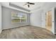 Large main bedroom with ceiling fan, tray ceiling, wood-look flooring, and large window at 3510 Brook Crossing Dr, Brandon, FL 33511