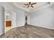 Large main bedroom with ceiling fan, tray ceiling, and wood-look flooring at 3510 Brook Crossing Dr, Brandon, FL 33511