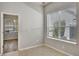 Bright room with a large window and tile flooring, adjacent to another room visible through the doorway at 3510 Brook Crossing Dr, Brandon, FL 33511