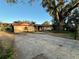 Charming single-story home featuring a red roof and inviting front yard with mature landscaping at 3521 Sumner Rd, Dover, FL 33527