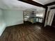 Spacious living room leading into a kitchen with an island and wood floors at 3521 Sumner Rd, Dover, FL 33527