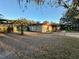 View of single-story home showcasing its spacious yard and pergola, ideal for outdoor entertaining at 3521 Sumner Rd, Dover, FL 33527