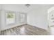 A bedroom with plenty of natural light, enhanced by modern wood-look floors at 3819 Queensboro S Ave, St Petersburg, FL 33711