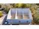 Aerial view of commercial building with concrete flooring and wire-mesh ceiling, set amongst lush greenery at 4049 Dolphin Dr, Tampa, FL 33617