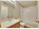 Bathroom with a vanity sink and tub with white tiling at 4049 Dolphin Dr, Tampa, FL 33617