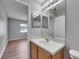 Bathroom with a sink, mirror and vanity, featuring a view into a bedroom at 4049 Dolphin Dr, Tampa, FL 33617