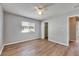 Spacious bedroom featuring a ceiling fan, natural light, and wood-look vinyl floors at 4049 Dolphin Dr, Tampa, FL 33617
