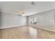 A bright bedroom with tile flooring, a ceiling fan, and a window at 4049 Dolphin Dr, Tampa, FL 33617
