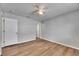 Neutral bedroom featuring a ceiling fan, bright walls, and wood-look vinyl floors at 4049 Dolphin Dr, Tampa, FL 33617