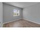 Neutral bedroom with a large window, baseboards, and vinyl flooring at 4049 Dolphin Dr, Tampa, FL 33617