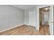 Neutral bedroom with a closet and attached bathroom with bright lighting and wood-look flooring at 4049 Dolphin Dr, Tampa, FL 33617