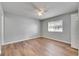 Spacious bedroom with a ceiling fan, natural light, and wood-look vinyl floors at 4049 Dolphin Dr, Tampa, FL 33617
