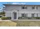 Charming two-story townhouse featuring a well-maintained lawn and gray shutters at 4049 Dolphin Dr, Tampa, FL 33617