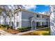 Two-story condo with manicured bushes and a defined entry way at 4049 Dolphin Dr, Tampa, FL 33617