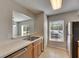 Open kitchen featuring wood cabinets, stainless steel sink, and natural lighting at 4049 Dolphin Dr, Tampa, FL 33617