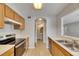 Well-lit kitchen with wooden cabinets, stainless steel appliances, and neutral countertops at 4049 Dolphin Dr, Tampa, FL 33617
