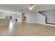 Open living space with tile flooring, ceiling fan, and a staircase at 4049 Dolphin Dr, Tampa, FL 33617
