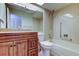 Cozy bathroom featuring tiled shower-tub combination and wood vanity at 4908 Lynchburg Ct, New Port Richey, FL 34655
