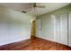 Bright bedroom with hardwood floors, ceiling fan, and closet at 4908 Lynchburg Ct, New Port Richey, FL 34655