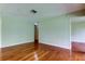 Neutral bedroom with hardwood floors and a door leading to a closet at 4908 Lynchburg Ct, New Port Richey, FL 34655