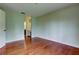 This bedroom offers hardwood floors, natural light, and neutral paint at 4908 Lynchburg Ct, New Port Richey, FL 34655