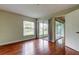 This bedroom features hardwood floors, natural light, and access to an enclosed lanai at 4908 Lynchburg Ct, New Port Richey, FL 34655