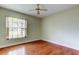 This bedroom offers hardwood floors and a large window offering natural light at 4908 Lynchburg Ct, New Port Richey, FL 34655