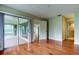 This bedroom features hardwood floors, natural light, and access to an enclosed lanai and bath at 4908 Lynchburg Ct, New Port Richey, FL 34655