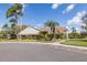 Exterior shot of the clubhouse, featuring lush landscaping and ample parking at 4908 Lynchburg Ct, New Port Richey, FL 34655