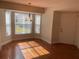 Bright dining area with hardwood floors, a bay window, and modern lighting fixture at 4908 Lynchburg Ct, New Port Richey, FL 34655