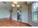 Open dining area with hardwood floors leading to a kitchen with stainless steel appliances at 4908 Lynchburg Ct, New Port Richey, FL 34655