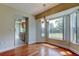 Dining room with bright windows, wood floor, and entry to the kitchen at 4908 Lynchburg Ct, New Port Richey, FL 34655