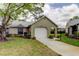 Charming home with a well-manicured lawn, a classic garage, and a welcoming facade at 4908 Lynchburg Ct, New Port Richey, FL 34655