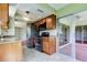 Well-lit kitchen with granite countertops, stainless steel appliances, and a sliding glass door at 4908 Lynchburg Ct, New Port Richey, FL 34655