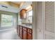 Kitchen features ample cabinets, granite counters and a double sink below a window at 4908 Lynchburg Ct, New Port Richey, FL 34655