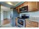 Kitchen view with stainless appliances, granite counters, and ample cabinet space at 4908 Lynchburg Ct, New Port Richey, FL 34655