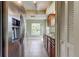 Updated kitchen with stainless steel fridge, granite countertops, and ample cabinet space at 4908 Lynchburg Ct, New Port Richey, FL 34655