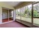 Screened lanai featuring carpet flooring with view of backyard at 4908 Lynchburg Ct, New Port Richey, FL 34655