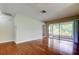 Cozy living room with hardwood floors and sliding doors to a screened patio at 4908 Lynchburg Ct, New Port Richey, FL 34655