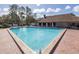 Beautiful pool is ideal for relaxation and recreation, surrounded by chairs and greenery at 4908 Lynchburg Ct, New Port Richey, FL 34655