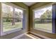 Enclosed porch with tile flooring and large windows for backyard views at 4908 Lynchburg Ct, New Port Richey, FL 34655