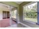 Enclosed porch with windows and views of the screened patio and backyard at 4908 Lynchburg Ct, New Port Richey, FL 34655