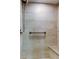 Walk in shower features updated tile, bronze hardware and built-in bench at 4908 Lynchburg Ct, New Port Richey, FL 34655
